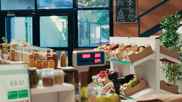 Empty eco friendly local store with weighting scale on counter, modern equipment used to measure pantry supplies in bulk and fresh ripe fruits or veggies. Neighborhood shop for sustainable lifestyle.