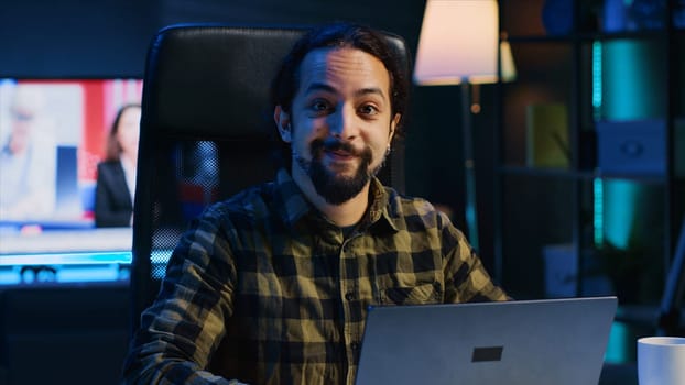 Portrait of smiling freelancer working from home, typing on laptop, surfing the net. Joyful remote employee browsing on digital device, sending emails to customers, camera A