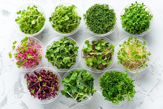 A variety of fresh microgreens are displayed in clear bowls against a white background, showcasing their vibrant green and purple hues.