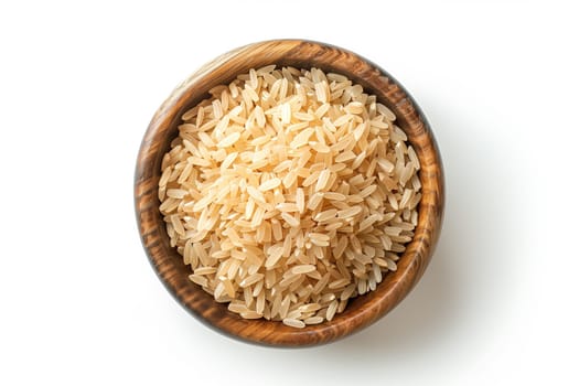 A wooden bowl filled with rice sits on top of a white table.