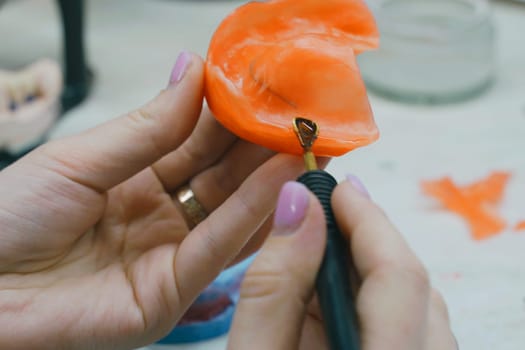 The dental technician makes a wax base and adds wax to form the mold. Side view. Dental concept