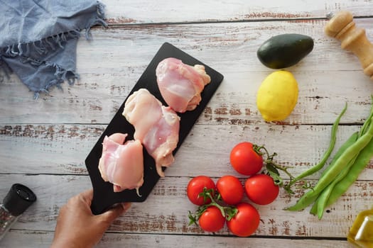 raw breast chicken meat on a plate on white background.