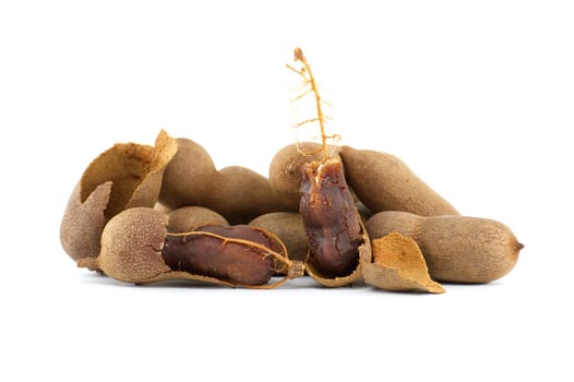 Pile of fresh whole tamarinds fruits isolated on white background