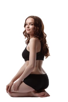 Image of smiling teenage girl in black sports underwear