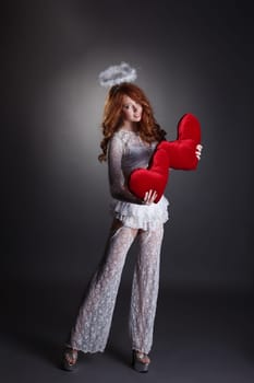 Image of lovely girl in angel costume posing with hearts