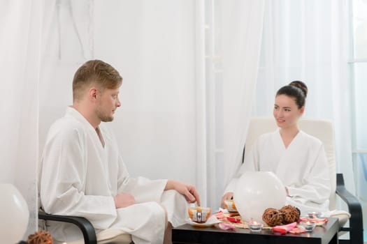 Photo of attractive man and woman relaxing in spa salon