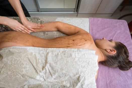 Top view of young woman getting procedure in spa salon