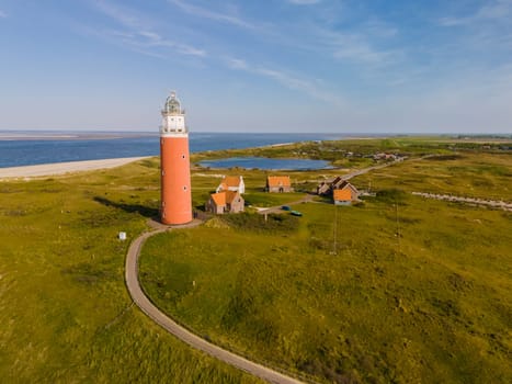 A majestic lighthouse stands tall near the endless ocean, casting its guiding light over the waters below.