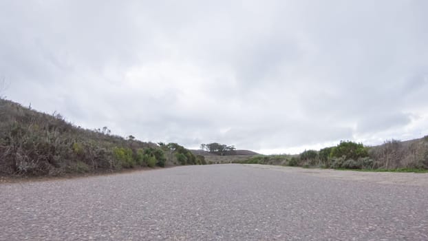 In this serene winter scene, a vehicle carefully makes its way along Los Osos Valley Road and Pecho Valley Road within Montana de Oro State Park.