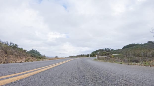 In this serene winter scene, a vehicle carefully makes its way along Los Osos Valley Road and Pecho Valley Road within Montana de Oro State Park.