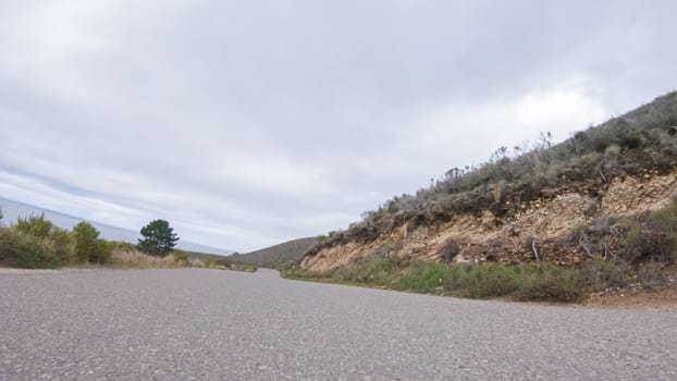 In this serene winter scene, a vehicle carefully makes its way along Los Osos Valley Road and Pecho Valley Road within Montana de Oro State Park.