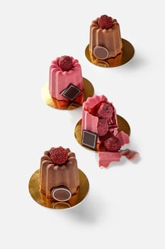 Delicious brittle Belgian chocolate shells with luxurious truffle candies inside, presented on gold cardboard discs against white backdrop. Designer dessert concept