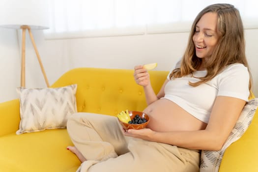 Pregnant woman eating healthy food fruit. High quality photo