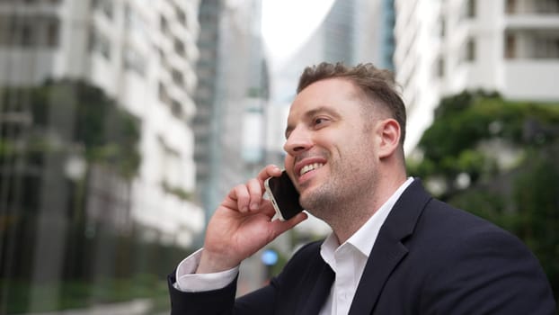 Businessman talking to manager about financial strategy by using phone with blurred background. Project manager calling investor and present marketing idea with blurred background. Lifestyle. Urbane.