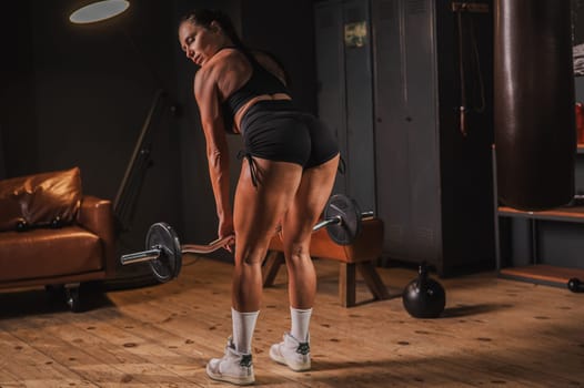 Caucasian woman doing deadlifts in retro gym