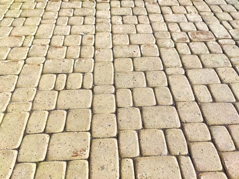 Bricks are like tiles on a sidewalk. Background, texture. Textured Brick Tile Pathway Under Daylight. A detailed view of a brick tile sidewalk with subtle color variations
