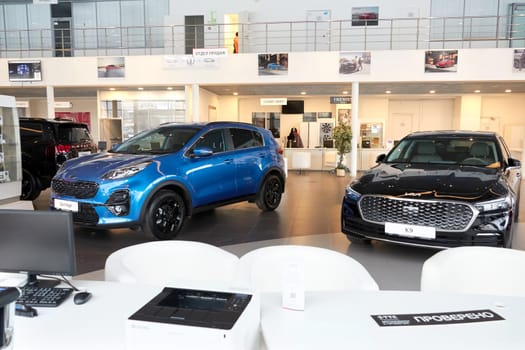 Kazan, Russia - November 25, 2022: Cars in showroom of dealership Kia in Kazan in Russia. Partial focus