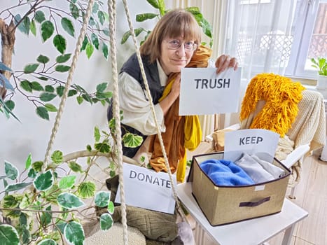 Middle-Aged Woman Sorting Belongings With KonMari Method. Mature woman categorizes items into keep and discard piles