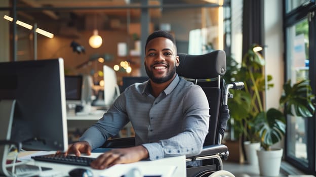 Happy smiling disabled employee man sitting in a wheelchair working at workplace in modern office