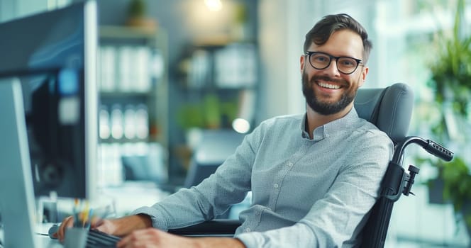 Happy smiling disabled employee man sitting in a wheelchair working at workplace in modern office