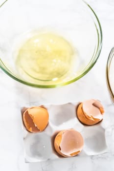 Separating egg whites and yolks to bake meringue cookies.