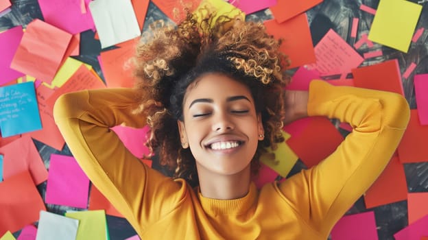 Business, office, creative relaxed african employee planning, with sticky notes for ideas, woman entrepreneur lying on the floor