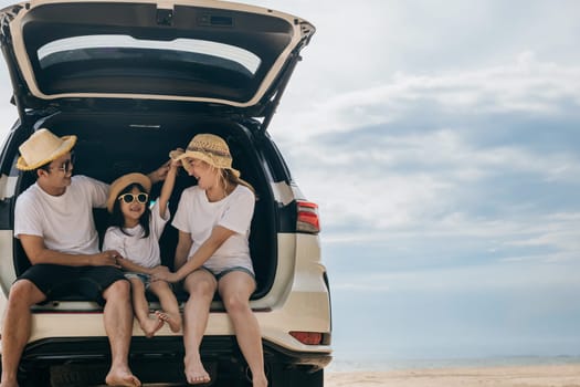 People enjoying road trip sitting on back their car, Parents and children traveling in holiday at sea beach, family having fun in summer vacation on beach blue sky, Happy Family and World Tourism Day