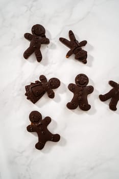Dusting chocolate ginger man with food golden dust for cake toppers.