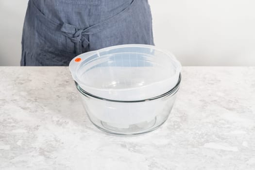 Washing dry rice in a rice washer and large glass bowl.