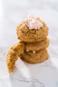 Eggnog cookies with a chocolate gingerbread man in a stack.