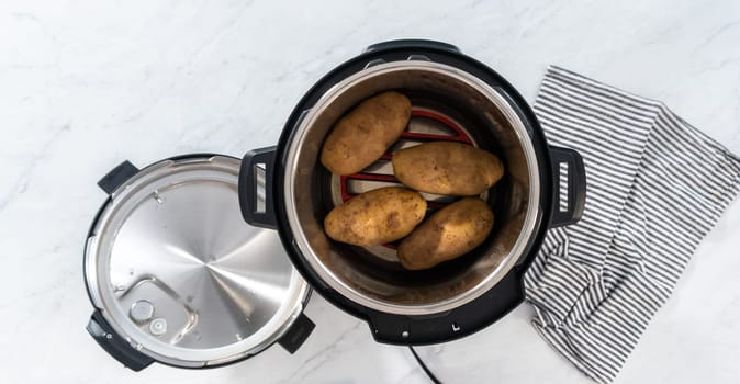 Flat lay. Pressure Cooker Baked Potatoes. Cooking whole potatoes in a pressure cooker to make baked potatoes.