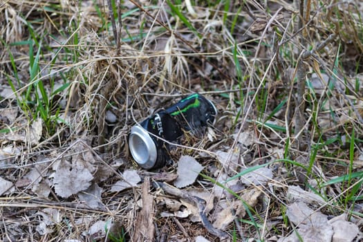 a soda can left out in the dirt at the park . High quality photo