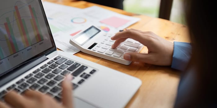 Accountant Using Calculator and Laptop, Concept of Financial Accounting.