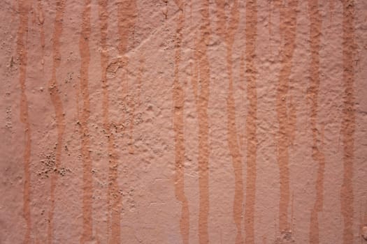 Horizontal view of textured urban background in peach fuzz color. Vintage wall with texture.