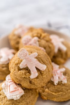 Eggnog cookies with a chocolate gingerbread man on a white plate.