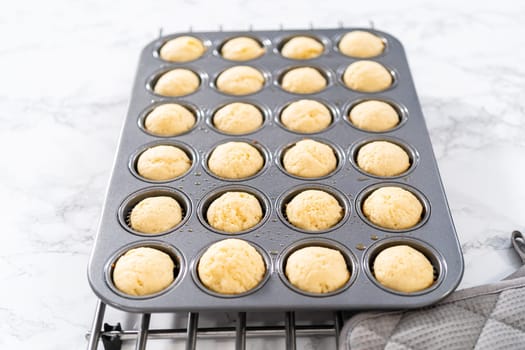 Cooling freshly baked American flag mini cupcakes on a kitchen counter.