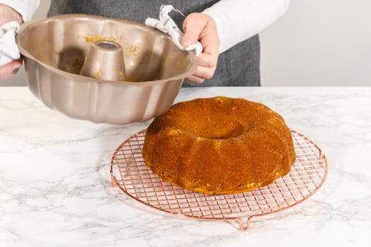 Cooling freshly baked pumpkin bundt cake on the kitchen counter.