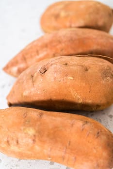 Measured ingredients in glass mixing bowls to make oven-roasted sweet potatoes
