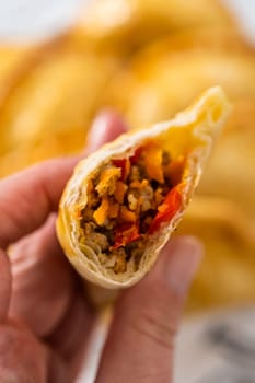 Freshly baked turkey empanadas on the kitchen counter.