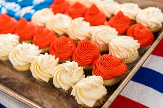 Arranging mini vanilla cupcakes in the shape of the American flag.