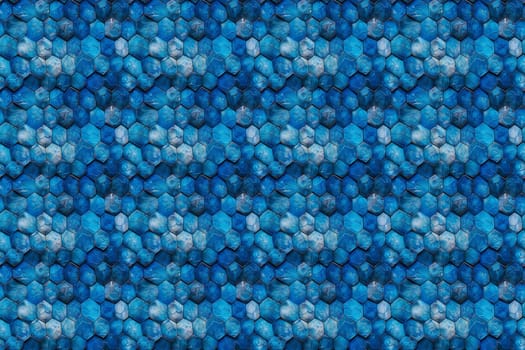 A close-up of a repeating pattern of blue hexagonal shapes. The hexagons are arranged in a slightly offset grid, creating a 3D effect.