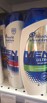 Bobruisk, Belarus - May 1, 2024: Several bottles of Head and Shoulders Ultra Mens shampoo are displayed neatly on a store shelf under bright lighting, showcasing the packaging design.