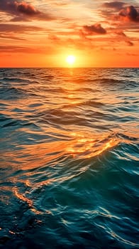 The sun is setting over the ocean, casting a warm glow on the water. The waves are small and gentle, creating a peaceful atmosphere