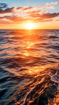 The sun is setting over the ocean, casting a warm glow on the water. The waves are small and gentle, creating a peaceful atmosphere