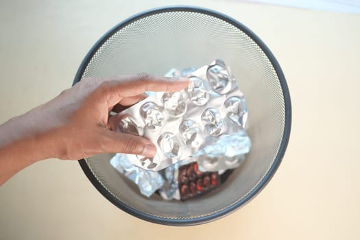 top view of pills and blister packs in a bin.