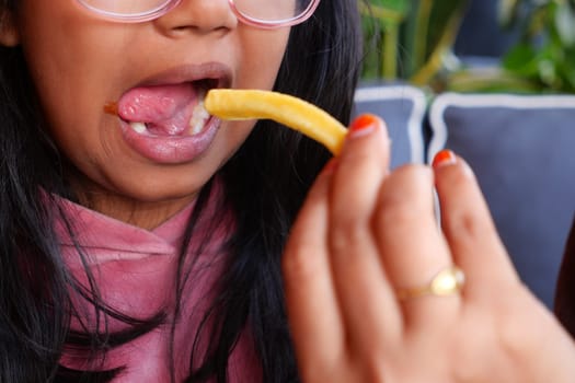 child eating french fries close up ,