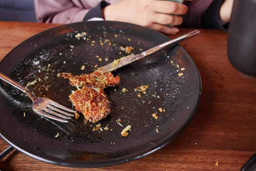 An empty dirty plate with a fork..