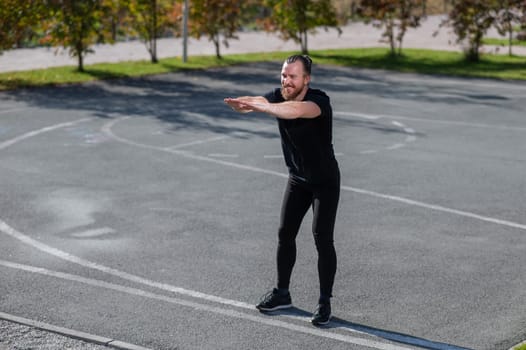 Bearded man doing exercises outdoors