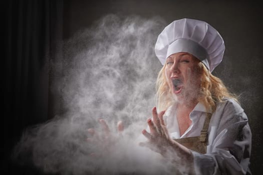 Fat funny female cook in a hat and apron posing and taking selfie in the kitchen with flour. Cooking, body positive, cloud, smoke, flour