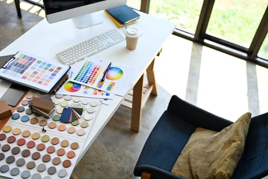 Above view of Interior designer working table with material sample and color palette.